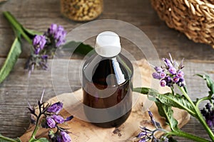 A bottle of homemade comfrey tincture on a table