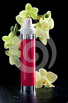 Bottle of cream/lotion/serum with orchids