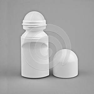 A bottle of deodorant on a gray background, makeup from the pot on an isolated background