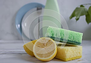 Bottle of dish detergent, lemon liquid  domesti, antiseptic detergent  cleanup   chemical  sterilize  sponge on a light background