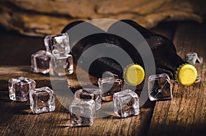 Bottle Draft Beer and ice on wooden table