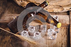 Bottle Draft Beer and ice on wooden table