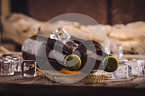 Bottle Draft Beer and ice on wooden table