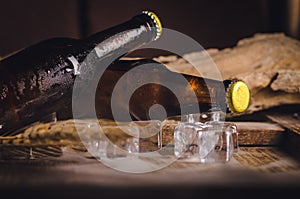 Bottle Draft Beer and ice on wooden table