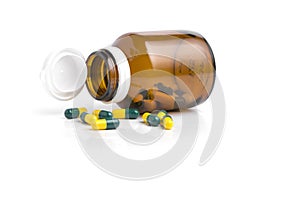 Bottle drug capsules on white background