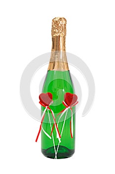 Bottle effervescent wine with two plush red hearts
