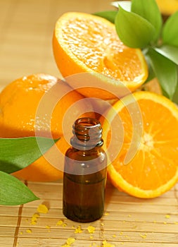 bottle of essence oil and oranges