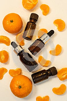 A bottle of essential oil, Aromatic tangerine oil in a dark bubble, cosmetic oil from tangerine. Bottles with sweet orange