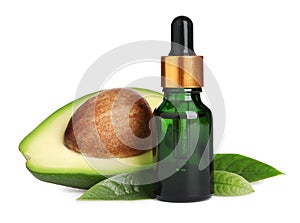 Bottle of essential oil, avocado and leaves on white background