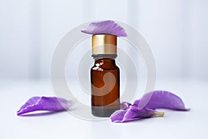 Bottle of essential oil with flowers