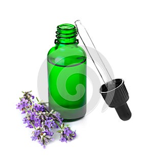 Bottle of essential oil and  flowers isolated on white