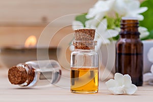 Bottle of essential oil and jasmin flower with shallow depth of