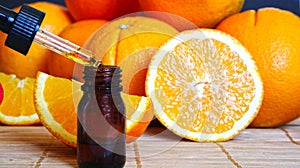 Bottle of essential oil from oranges on wooden background with pieces of oranges - alternative medicine. Essential aroma oil with