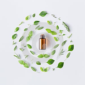 Bottle of essential oil with round shape of fresh herbs and spic