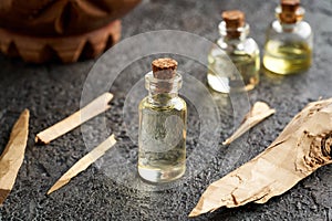 A bottle of essential oil with white sandalwood