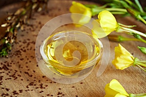 A bottle of evening primrose oil with fresh blooming evening primrose