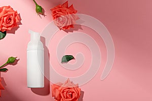 Bottle with facial product isolated in pink background. Blank unbranded tube in mockup style. Copy space in right side. Skincare