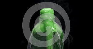 Bottle filled with toxic green liquid bubbling up and smoking. Concept for suicide by poison, murder, or poisonous substances