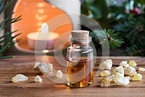 A bottle of frankincense essential oil with frankincense crystal