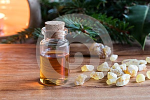 A bottle of frankincense essential oil with frankincense resin