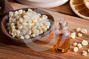 A bottle of frankincense essential oil with frankincense resin