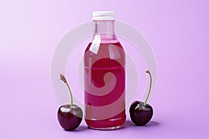 Bottle of fresh cherry juice and cheries lie on purple, lilac background