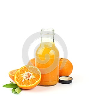 Bottle of fresh orange juice and sweet orange fruit on white background