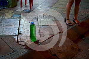 Bottle full of gasoline for sale on a sidewalk