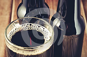 bottle and full glass beer/bottle and full glass beer on a wooden background. Close up