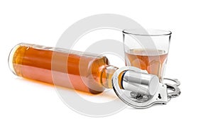 Bottle and glass with alcohol drink and handcuffs on white. Alcohol dependence concept