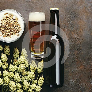 Bottle and Glass beer with Brewing ingredients. Hop flower with wheat. Top view. Copy space. Still life. Flat lay