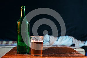 Bottle and glass of beer. Chilled beverage makes the glass be misted and covered with water drops. Huge free space for your text