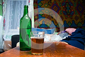 Bottle and glass of beer. Chilled beverage makes the glass be misted and covered with water drops. Huge free space for your text