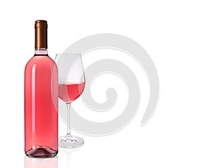 Bottle and glass of delicious rose wine on white background