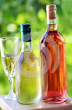 Bottle and glass of green and rose wine