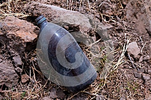 Bottle glass insecticide garbage on the farmer ground, polluted waste concept, garbage waste of pesticides bottle on floor,