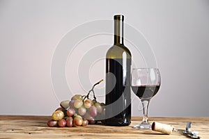 Bottle and glass of Red wine with grapes