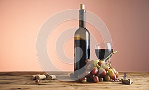 Bottle and glass of Red wine with grapes