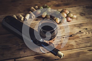 Bottle and glass of Red wine with grapes