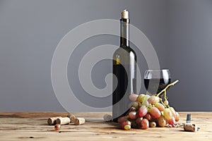 Bottle and glass of Red wine with grapes