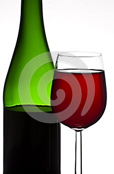 Bottle and glass of red wine isolated