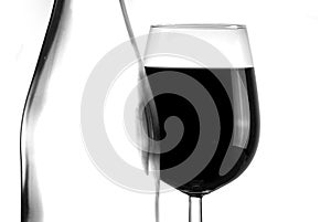 Bottle and glass of red wine isolated on white