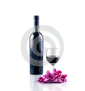 Bottle and glass of red wine isolated on white background.