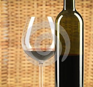 Bottle and glass of wine wicker background