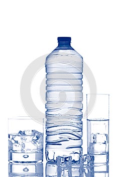 Bottle and glasses of mineral water with ice cubes