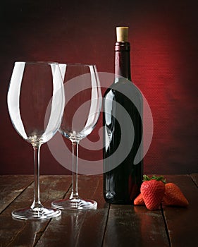 Bottle and glasses with red wine