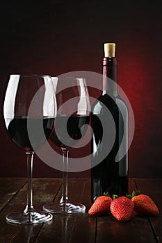 Bottle and glasses with red wine