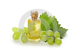 Bottle with grape seed oil on white background