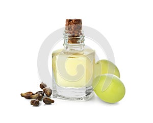 Bottle with grape seed oil on white background