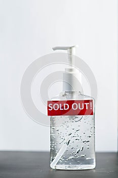 Bottle of hand sanitizer, hand desinfection gel and red label with Sold Out text. Symbol of coronavirus panic